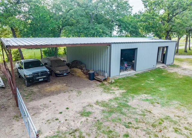 a view of a car park in front of a house