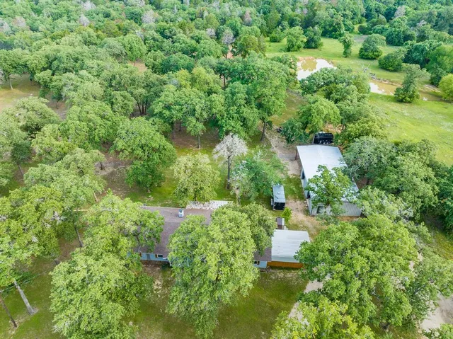 an aerial view of a house with a yard