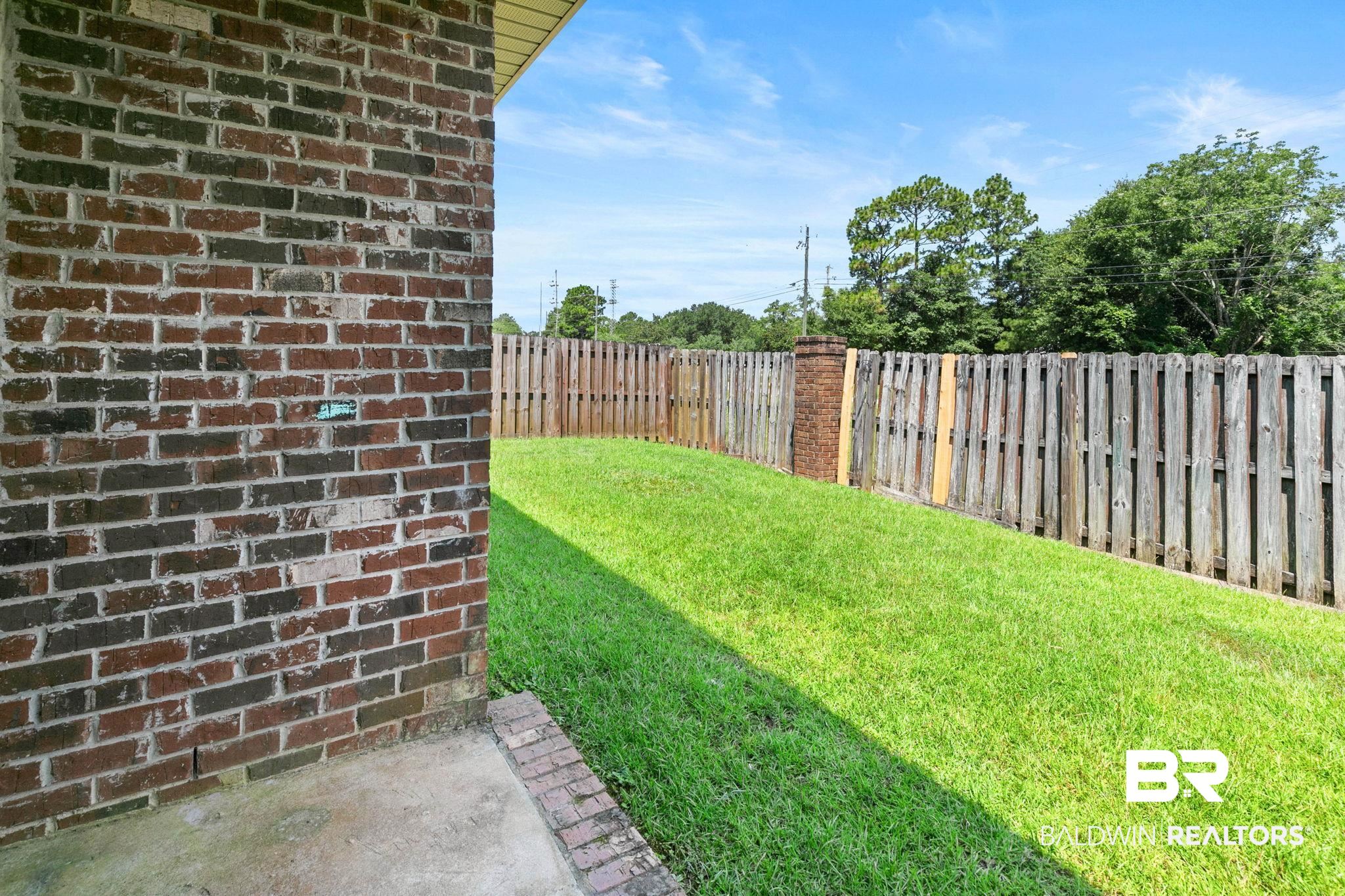 2216 Livingstone Court Mobile, AL 36695 - Photo 41 of 62 Expansive backyard featuring a manicured lawn, a full privacy fence, and mature trees beyond