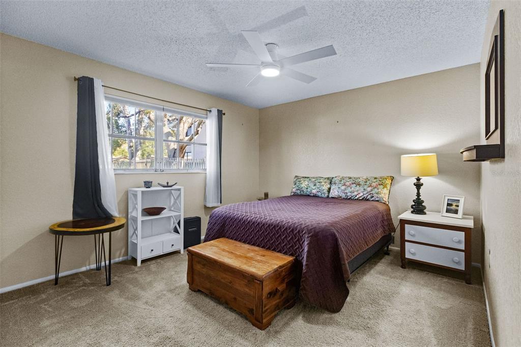 1417 Heather Ridge Boulevard Dunedin, FL 34698 - Photo 20 of 37 a spacious bedroom with a bed and a window