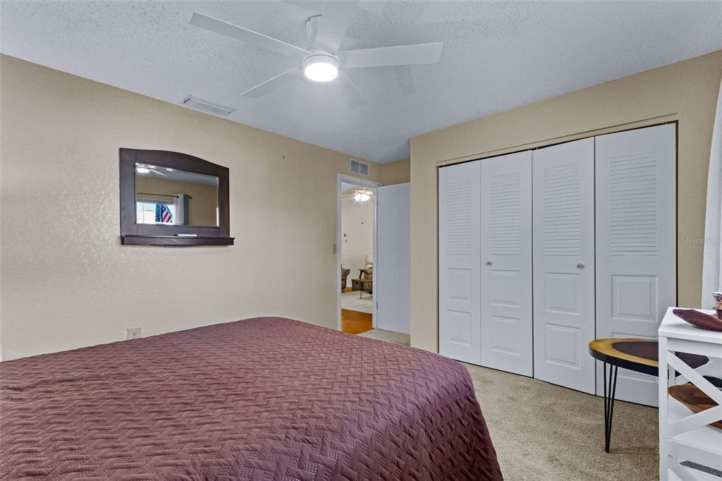 1417 Heather Ridge Boulevard Dunedin, FL 34698 - Photo 21 of 37 a bedroom with a bed and a chair