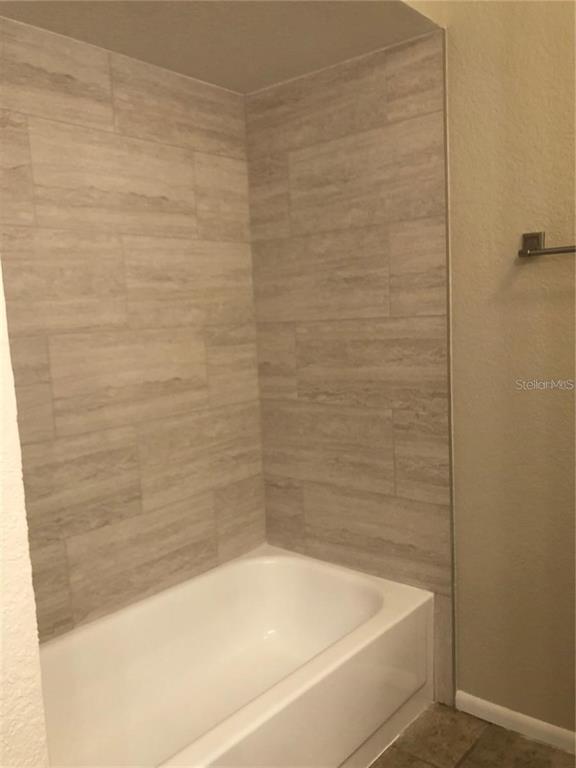 1417 Heather Ridge Boulevard Dunedin, FL 34698 - Photo 24 of 37 a bathroom with a bathtub