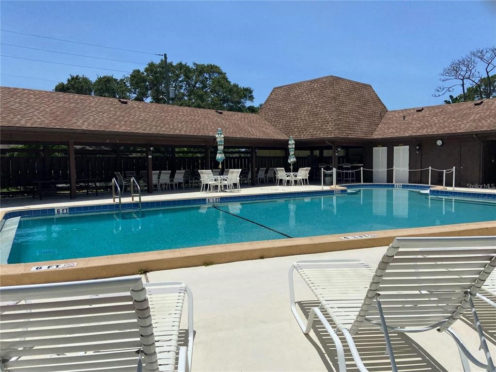 1417 Heather Ridge Boulevard Dunedin, FL 34698 - Photo 28 of 37 a view of house with outdoor space and swimming pool