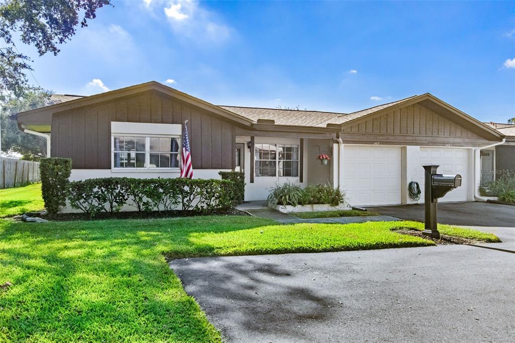 1417 Heather Ridge Boulevard Dunedin, FL 34698 - Photo 34 of 37 a house with garden in front of it