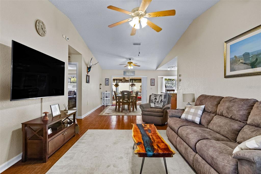1417 Heather Ridge Boulevard Dunedin, FL 34698 - Photo 5 of 37 a living room with furniture and a flat screen tv