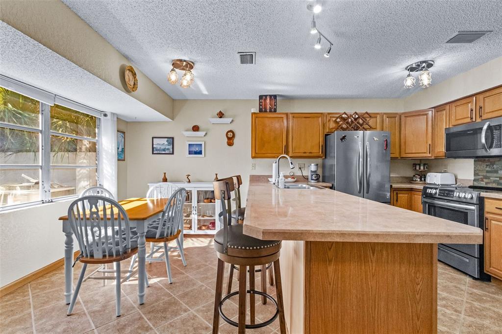 1417 Heather Ridge Boulevard Dunedin, FL 34698 - Photo 8 of 37 a view of a dining room with furniture