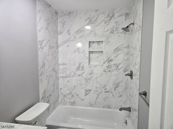 a bathroom with a bathtub and a toilet