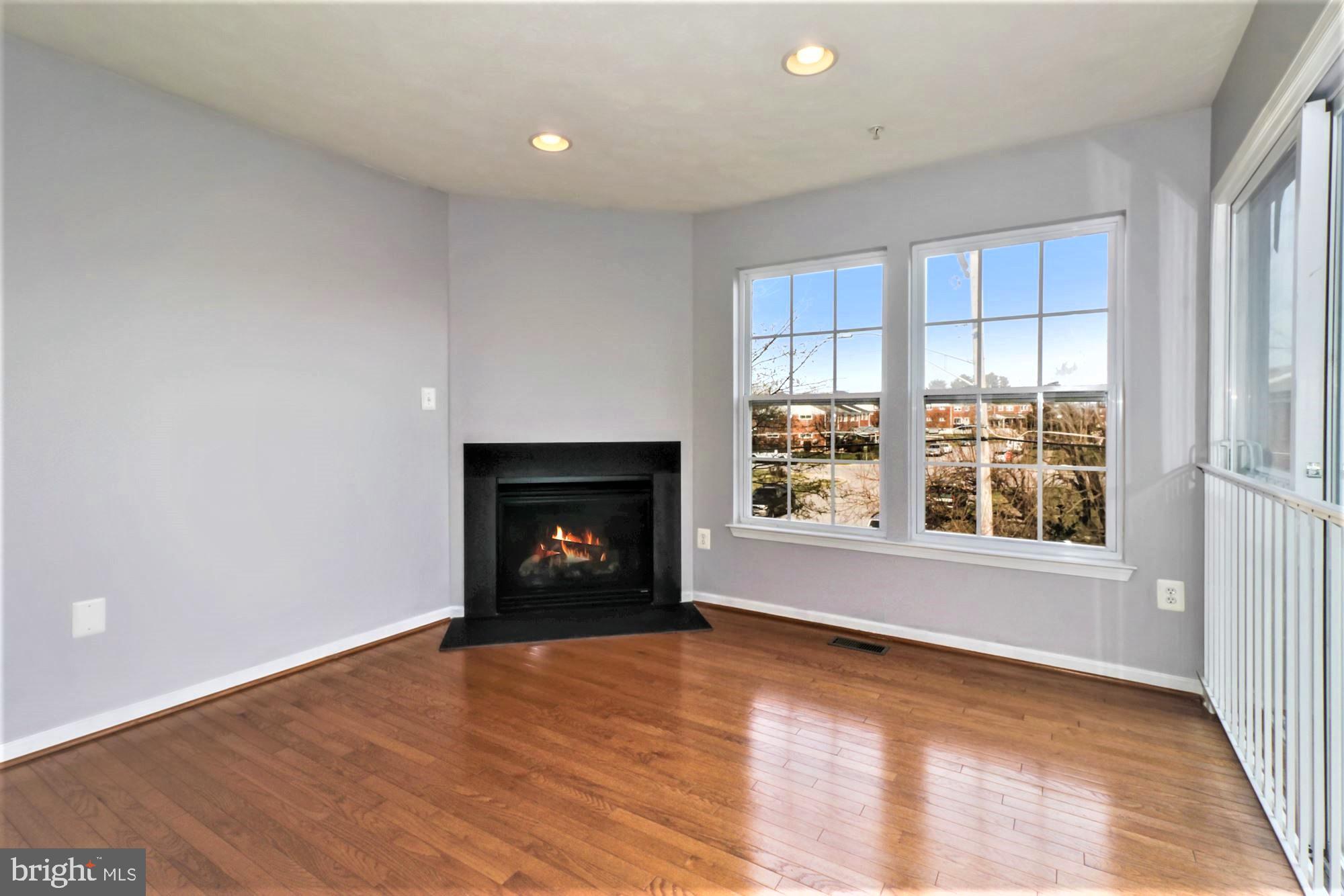 9840 Decatur Road Baltimore, MD 21220 - Photo 9 of 28 Living Room fireplace and Hdwd floor in Den