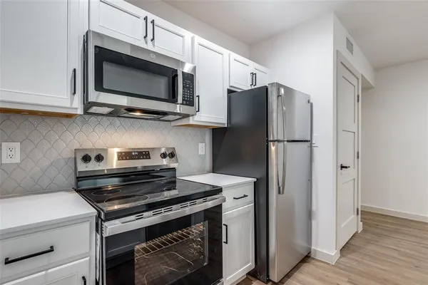 a kitchen with a stove and a microwave