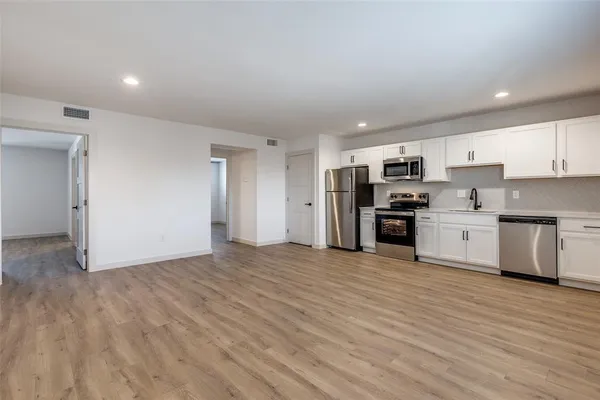 a view of kitchen with stainless steel appliances refrigerator and microwave