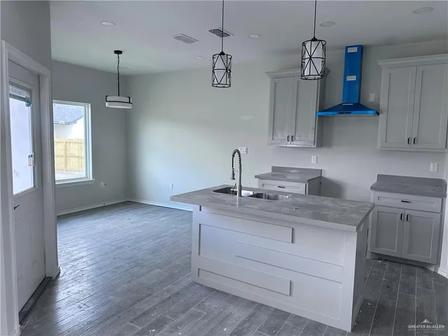 a kitchen with a sink cabinets and window