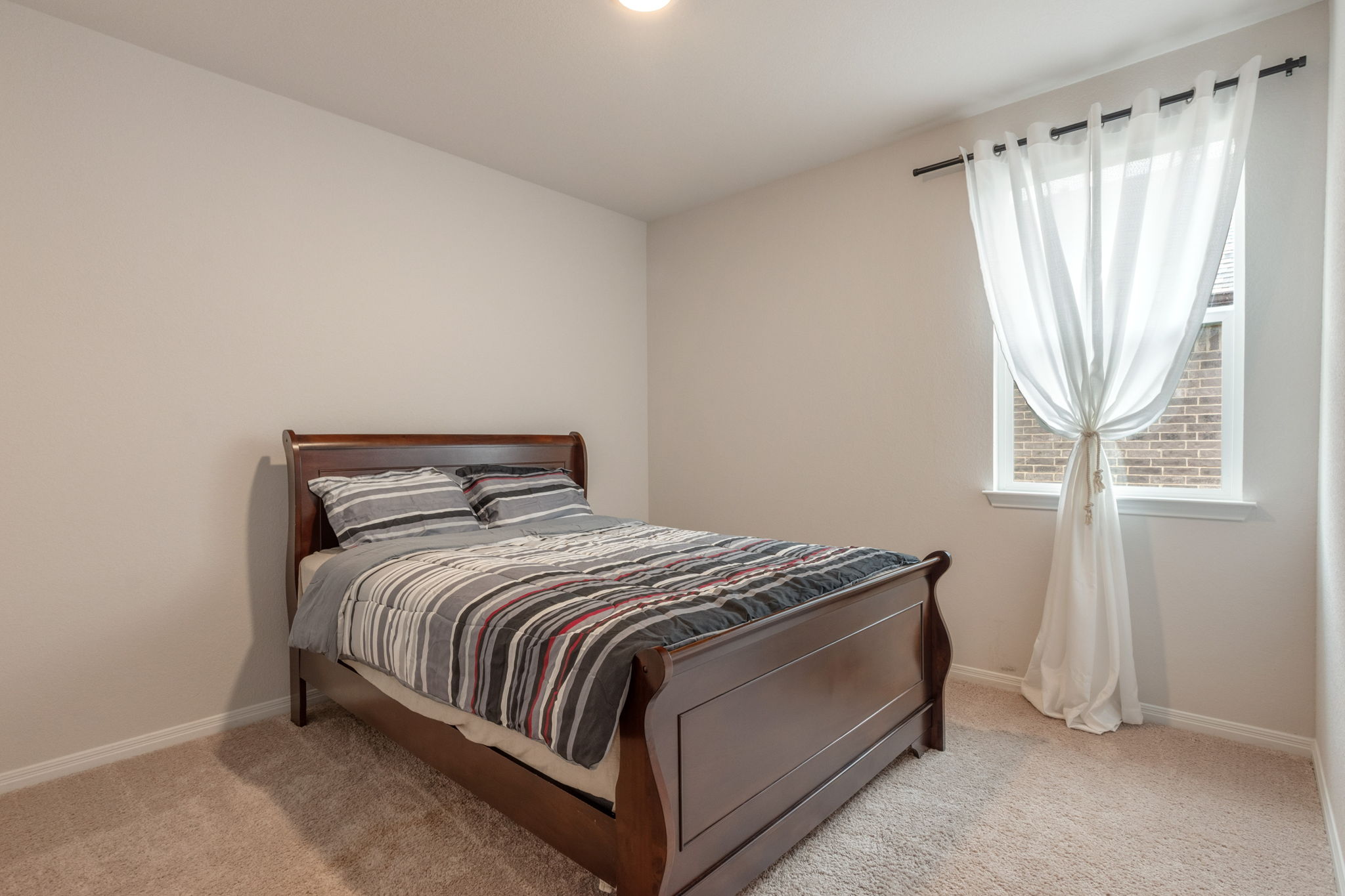 205 Charles Trail Georgetown, TX 78626 - Photo 18 of 36 Bedroom featuring baseboards and light colored carpet