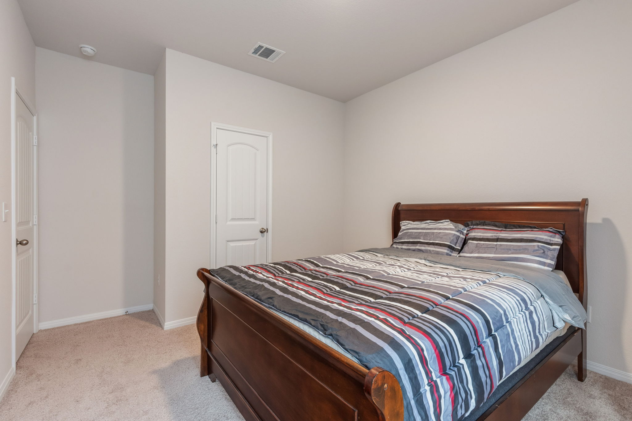 205 Charles Trail Georgetown, TX 78626 - Photo 19 of 36 Bedroom featuring light colored carpet and baseboards