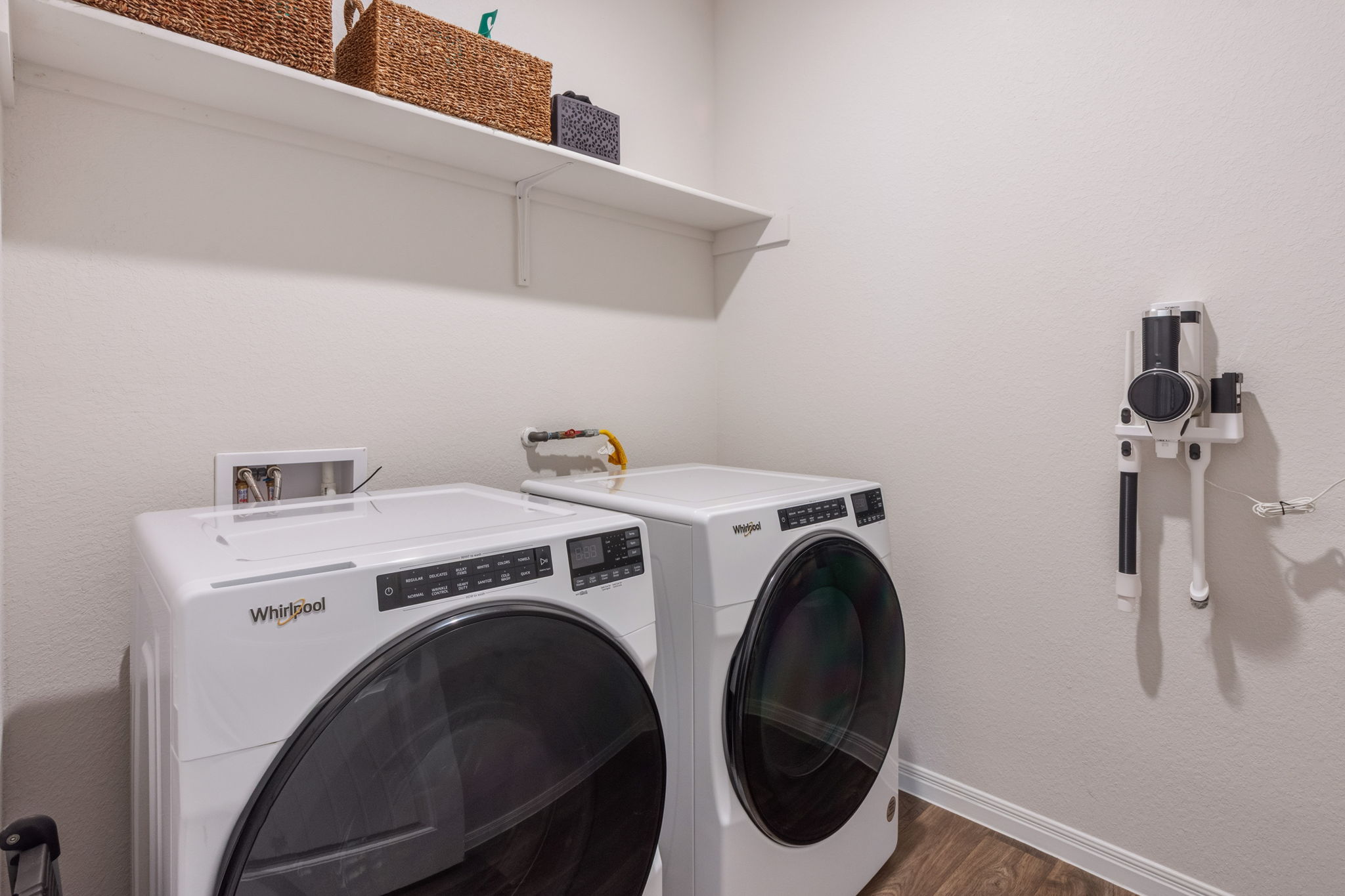 205 Charles Trail Georgetown, TX 78626 - Photo 20 of 36 Laundry area with washing machine and dryer, wood finished floors, and a textured wall