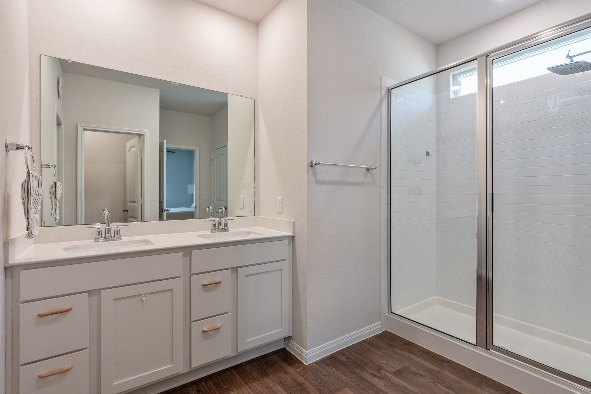 205 Charles Trail Georgetown, TX 78626 - Photo 27 of 36 Full bathroom with a stall shower, double vanity, and dark wood finished floors