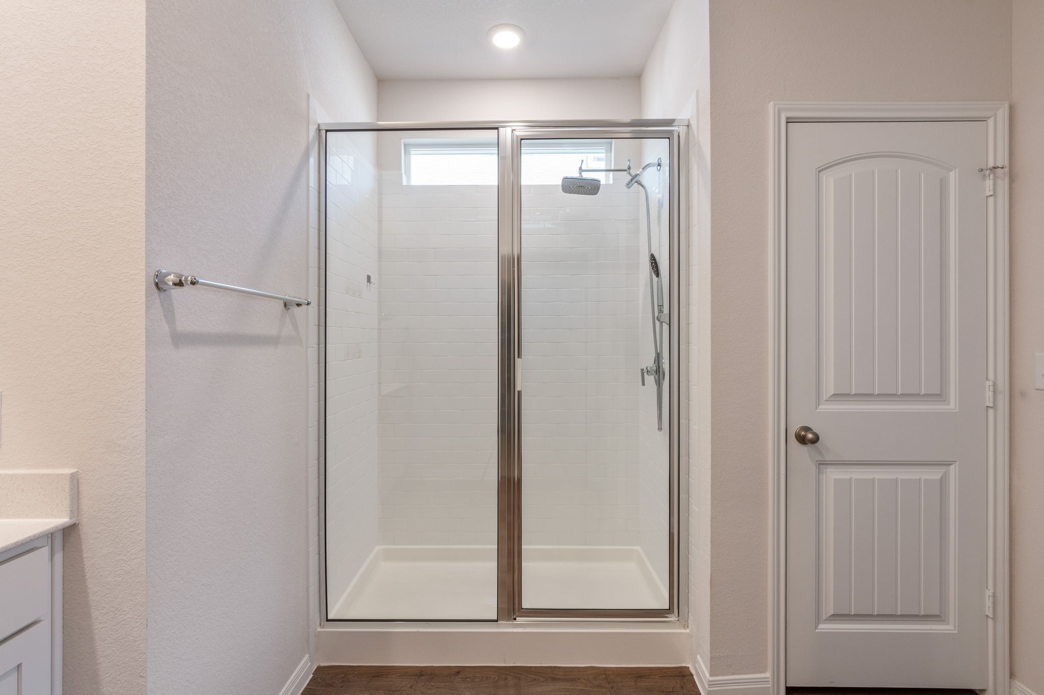 205 Charles Trail Georgetown, TX 78626 - Photo 28 of 36 Bathroom featuring a stall shower, vanity, a textured wall, and dark wood finished floors