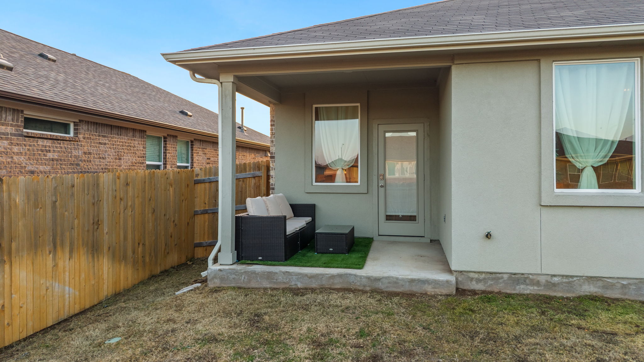 205 Charles Trail Georgetown, TX 78626 - Photo 29 of 36 View of exterior entry featuring a patio area, roof with shingles, and stucco siding