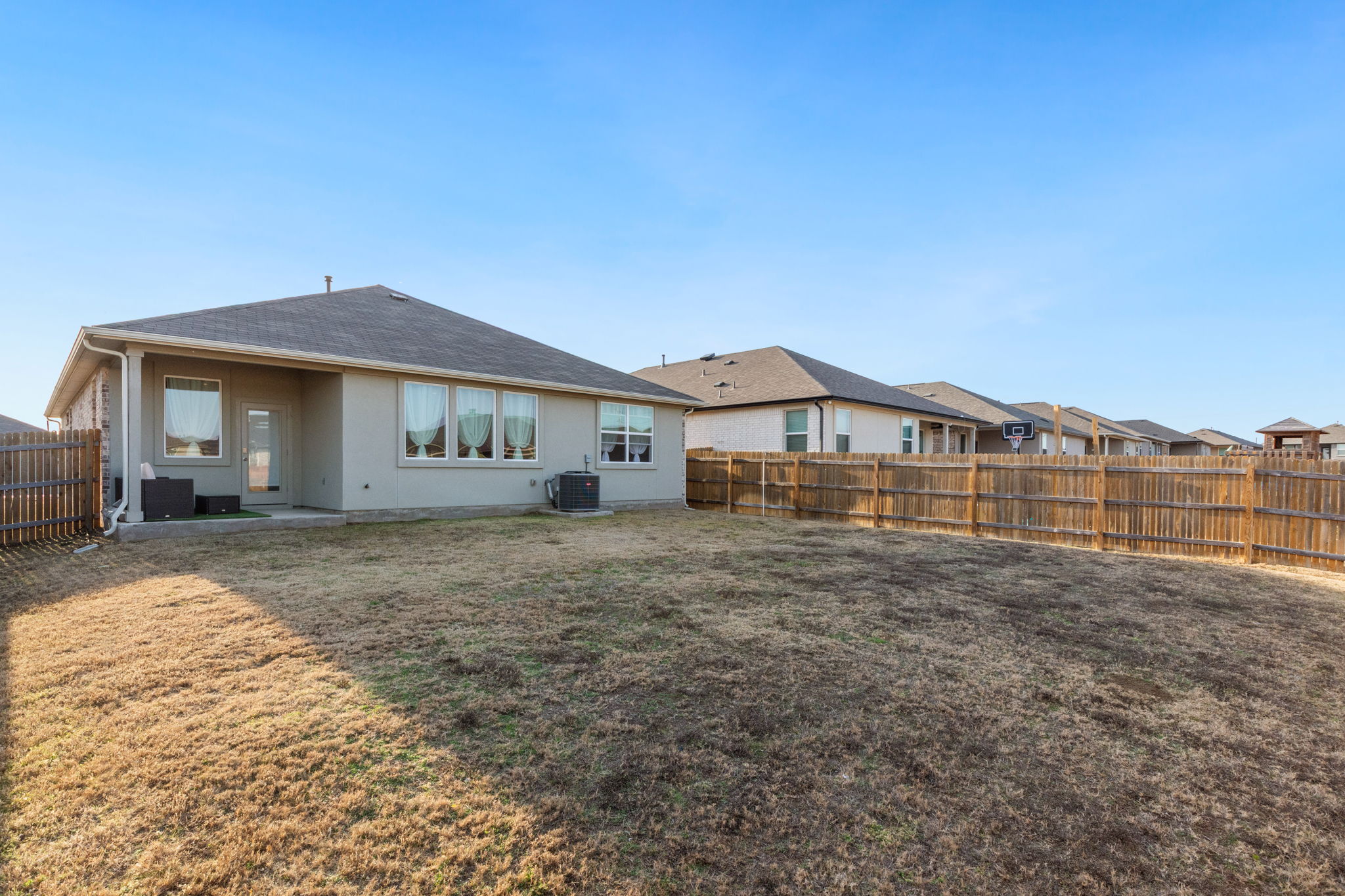 205 Charles Trail Georgetown, TX 78626 - Photo 30 of 36 Rear view of house featuring a patio area, a fenced backyard, and a residential view