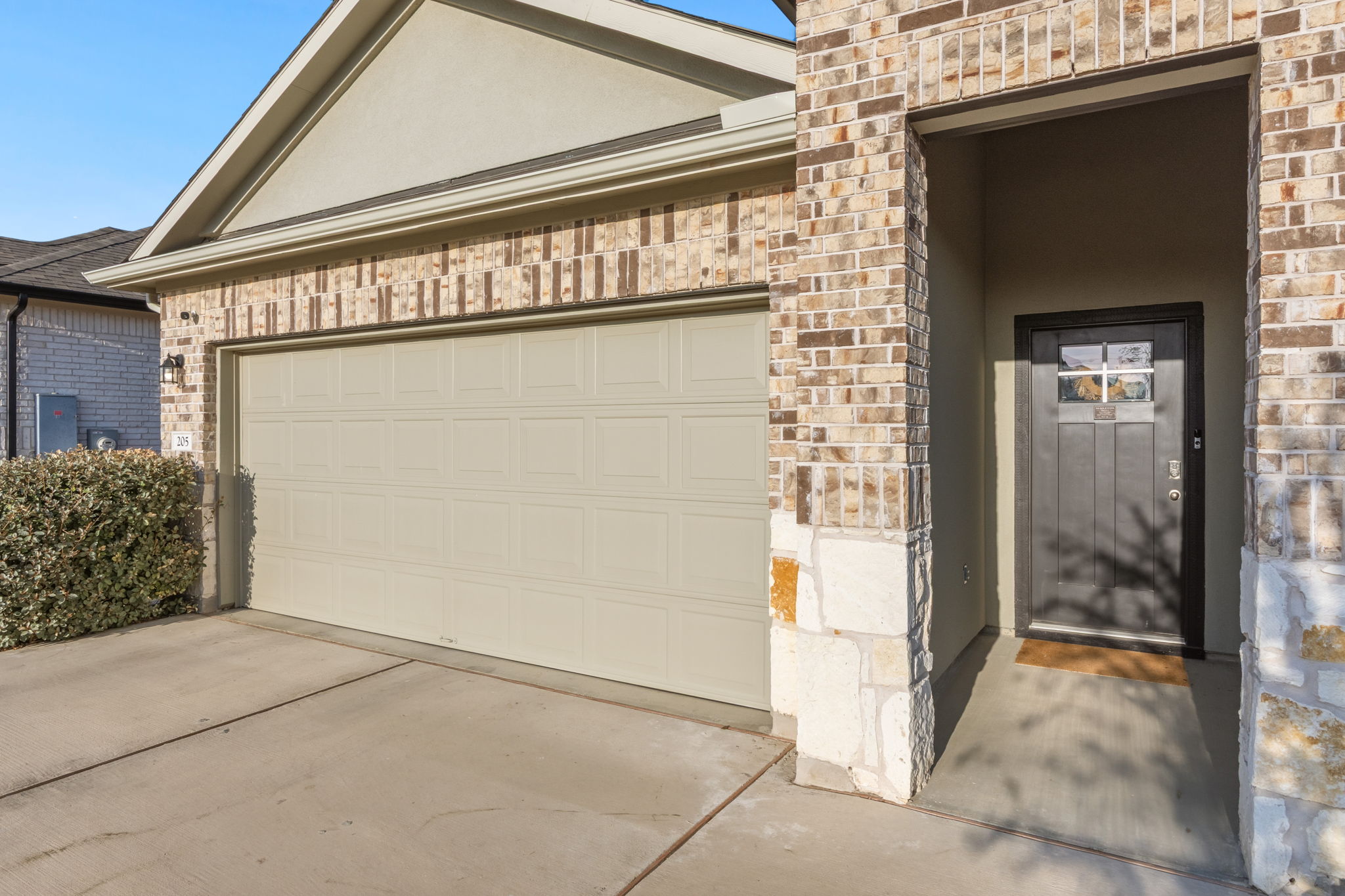 205 Charles Trail Georgetown, TX 78626 - Photo 6 of 36 Garage with concrete driveway and front entry way