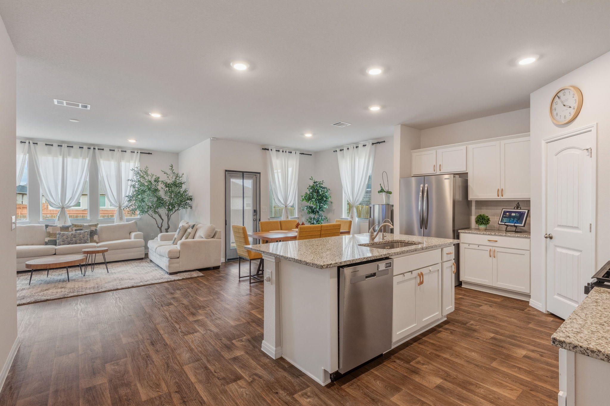 205 Charles Trail Georgetown, TX 78626 - Photo 10 of 36 Kitchen featuring white cabinetry, stainless steel appliances, light stone counters, dark wood finished floors, and recessed lighting
