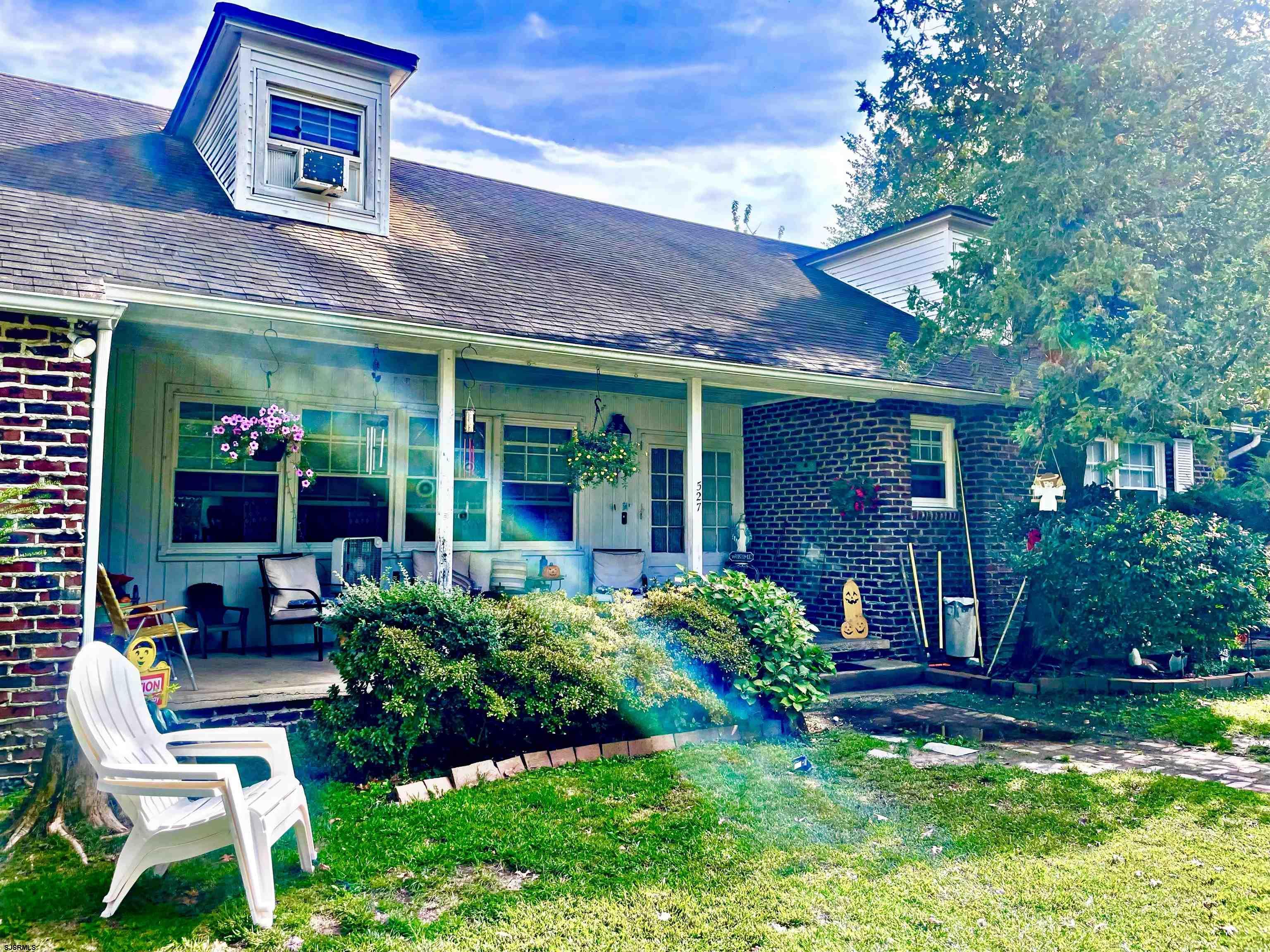 a view of a chair and table in front of house