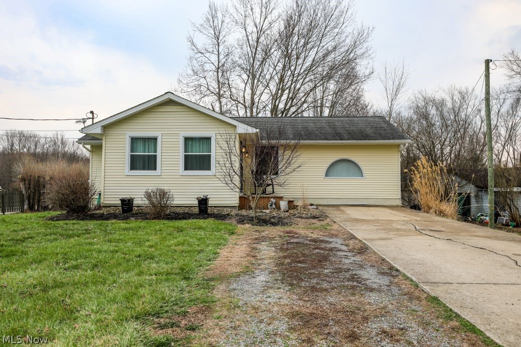 10676 Holcomb Road Newton Falls, OH 44444 - Photo 2 of 38 Ranch-style house with a front lawn and concrete driveway