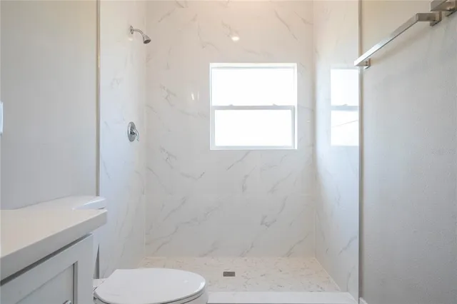 an empty room with window and wooden floor