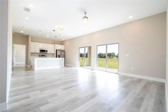a large white kitchen with a refrigerator a stove top oven a sink and dishwasher