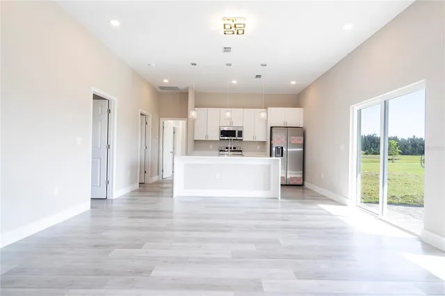 a view of kitchen with wooden floor and window