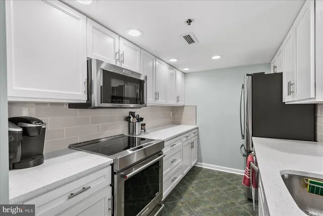 a kitchen that has a sink and a stove
