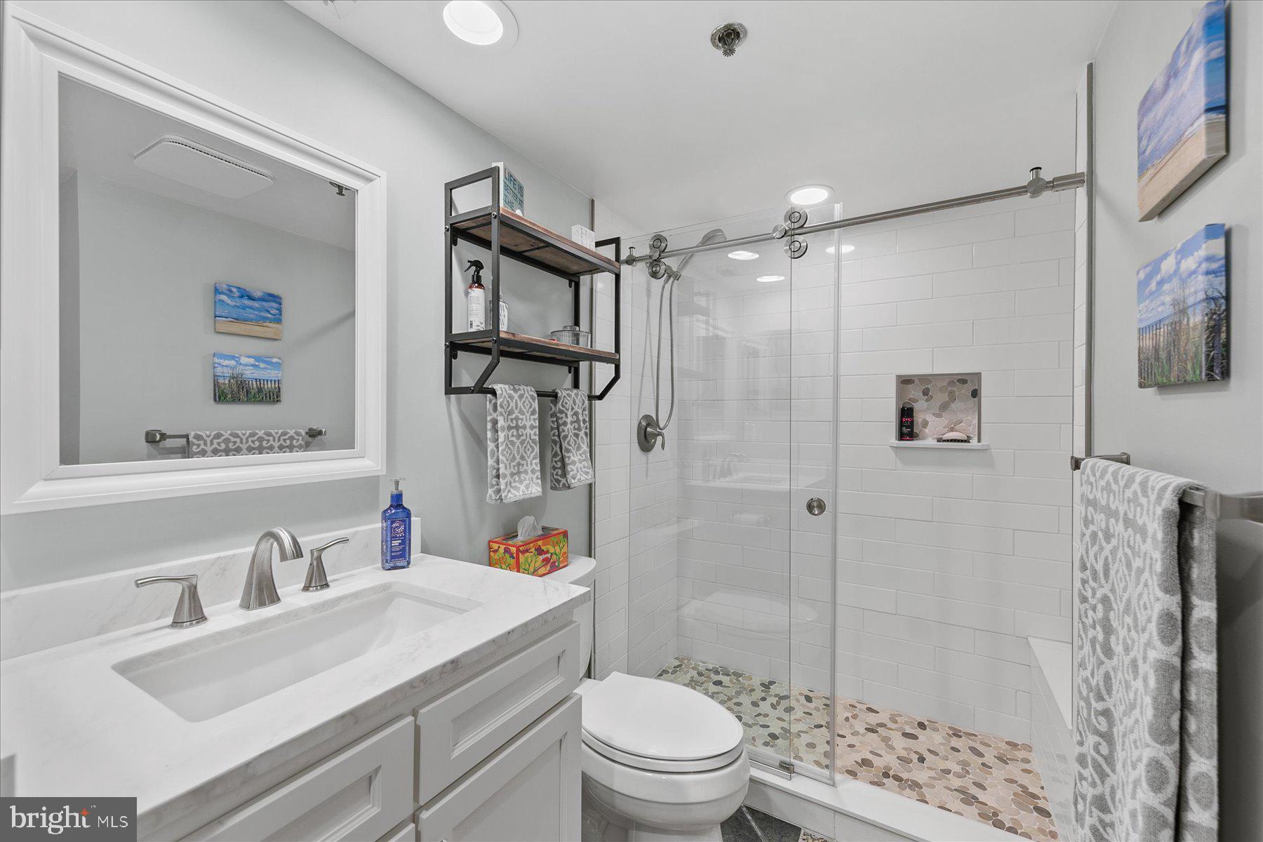 512 Georgetown House, Unit 512 Bethany Beach, DE 19930 - Photo 22 of 28 a bathroom with a sink toilet vanity and shower