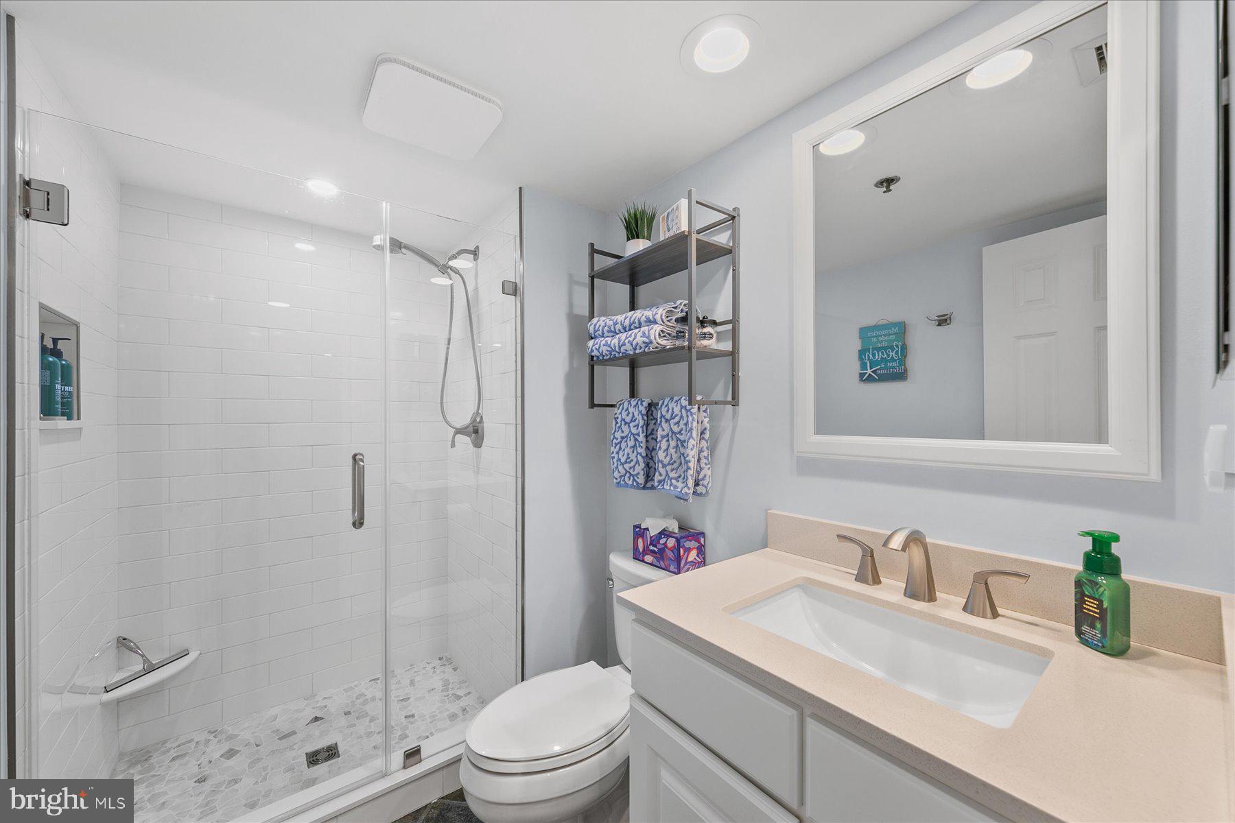 512 Georgetown House, Unit 512 Bethany Beach, DE 19930 - Photo 27 of 28 a bathroom with a sink a toilet and shower