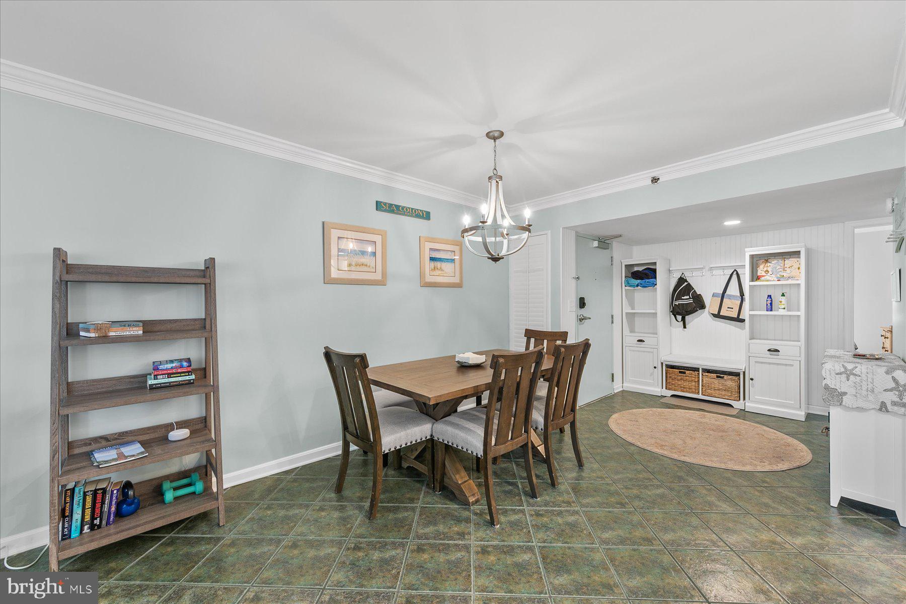 512 Georgetown House, Unit 512 Bethany Beach, DE 19930 - Photo 8 of 28 a view of a dining room with furniture and chandelier
