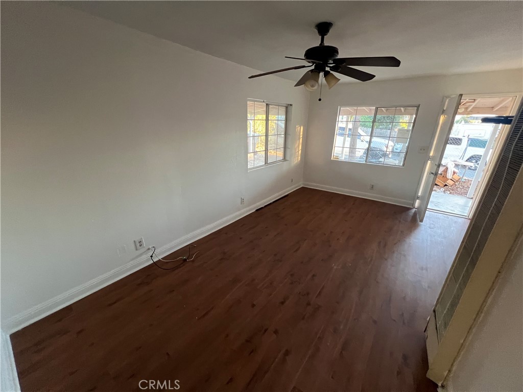 23828 Mt Vernon Place Menifee, CA 92587 - Photo 7 of 10 a view of empty room with wooden floor and fan