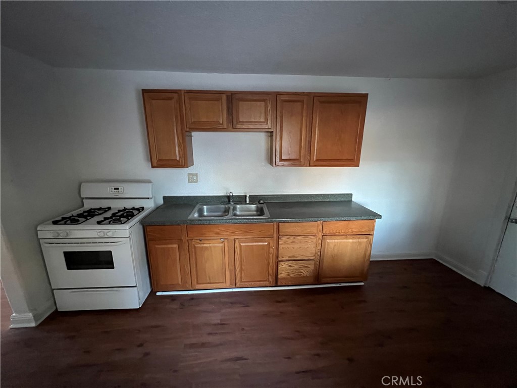 23828 Mt Vernon Place Menifee, CA 92587 - Photo 8 of 10 a kitchen with granite countertop a stove and a wooden floors