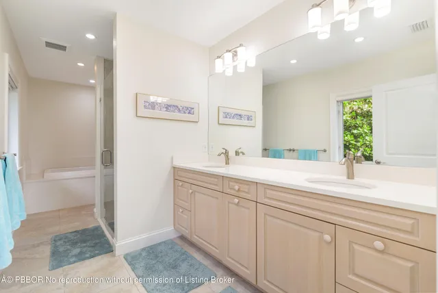 an aerial view of ocean and residential houses with outdoor space