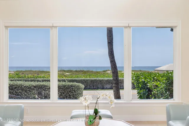 a view of a house with a big yard and large trees