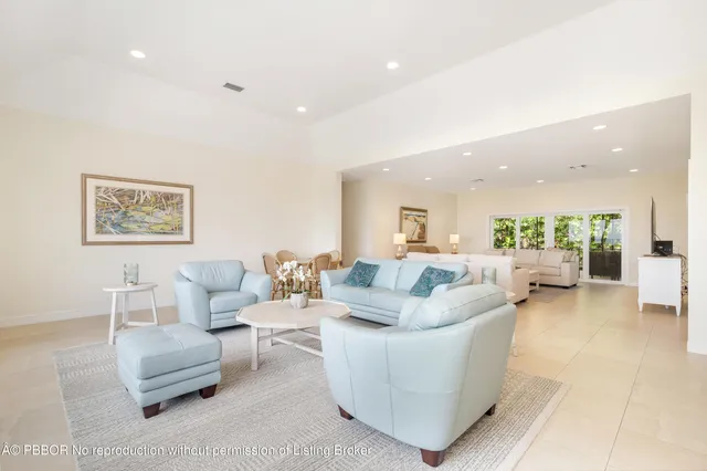 a view of a dining room with furniture a chandelier and a large window