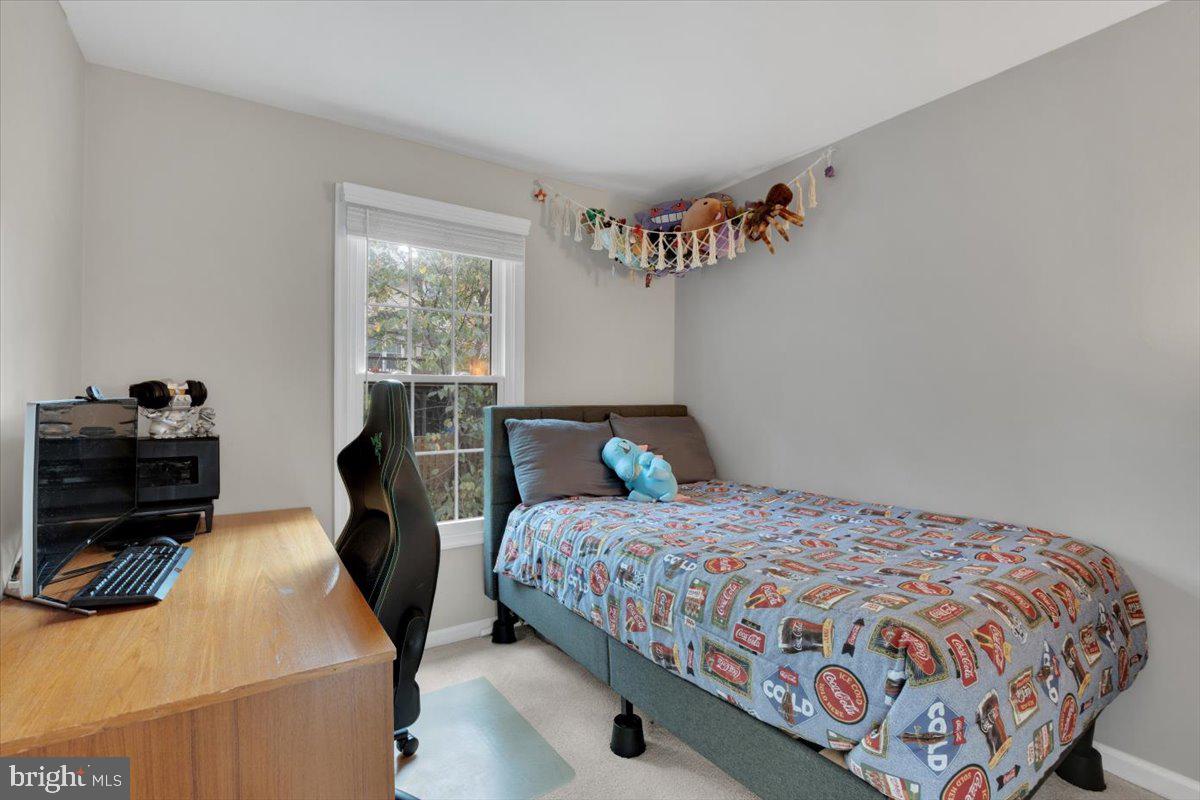 10700 Winfield Loop Manassas, VA 20109 - Photo 20 of 31 a bedroom with a bed and wooden floor