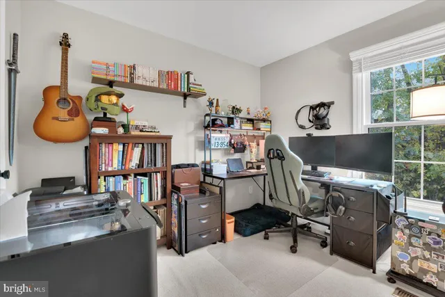 a view of a workspace with furniture and a window