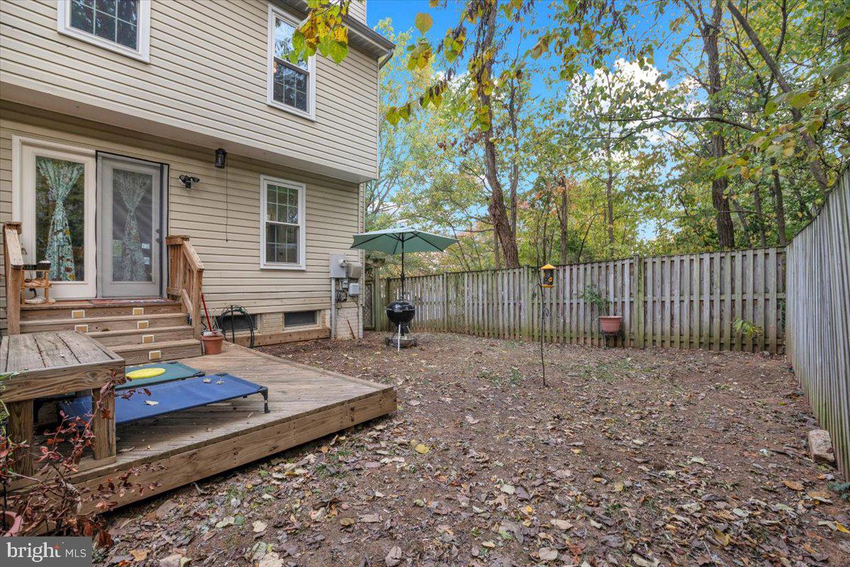 10700 Winfield Loop Manassas, VA 20109 - Photo 26 of 31 a backyard of a house with wooden fence
