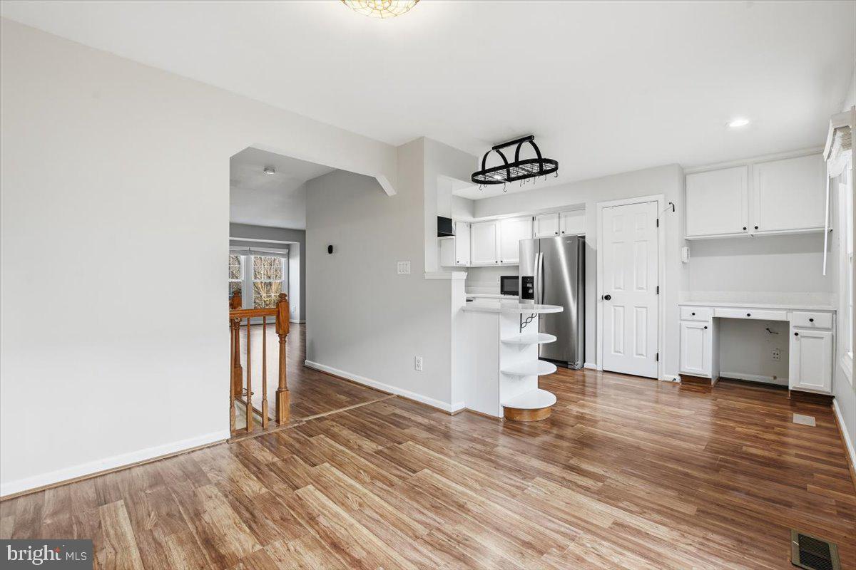 10700 Winfield Loop Manassas, VA 20109 - Photo 9 of 31 a view of a kitchen with a refrigerator and a stove top oven