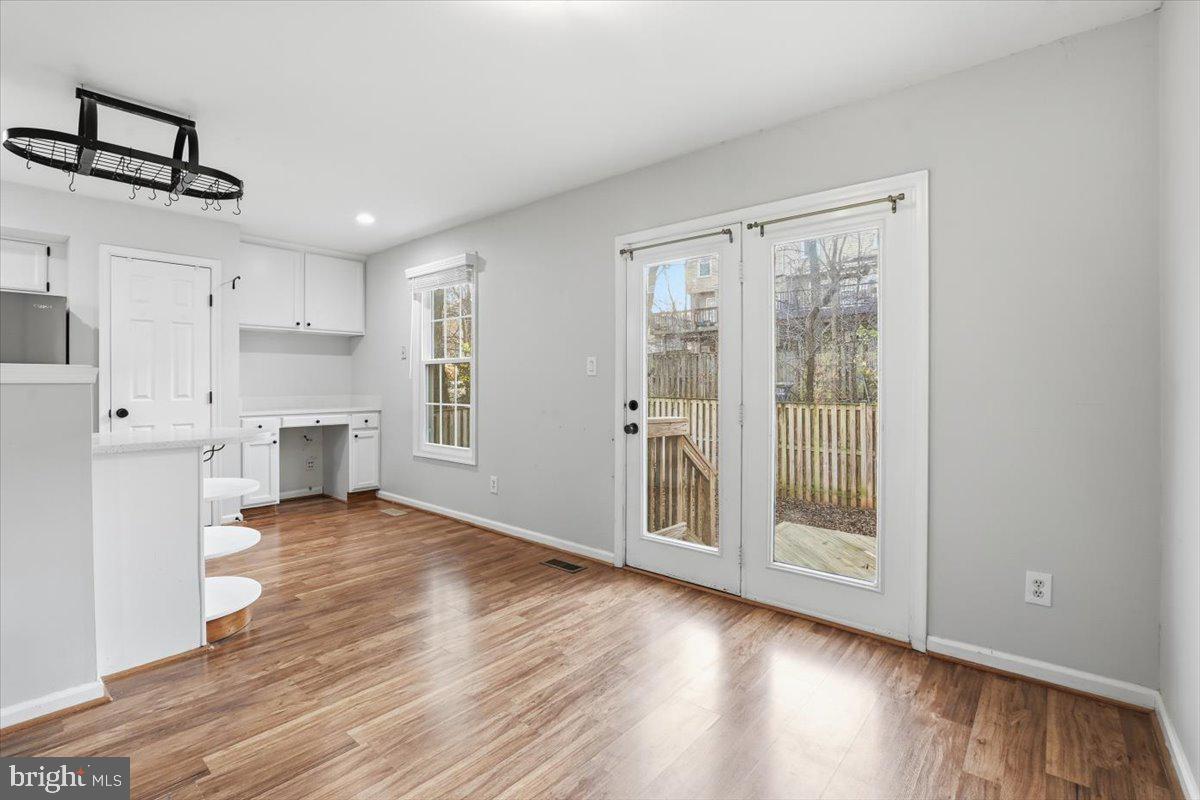 10700 Winfield Loop Manassas, VA 20109 - Photo 10 of 31 a view of a kitchen with wooden floor and a window