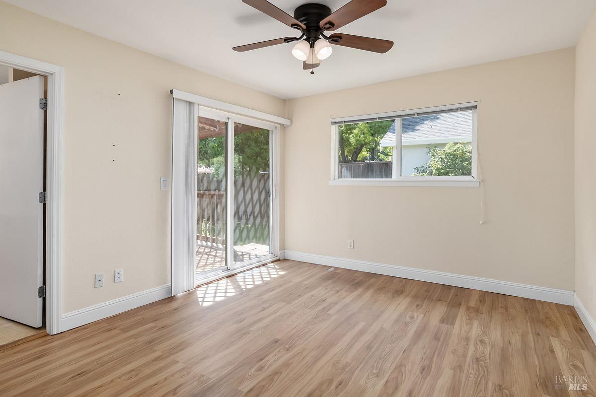 1135 4th Street Novato, CA 94945 - Photo 12 of 47 Another view of primary suite. There is an attached bathroom and a walk-in closet. The sliding door leads to a small deck and the backyard