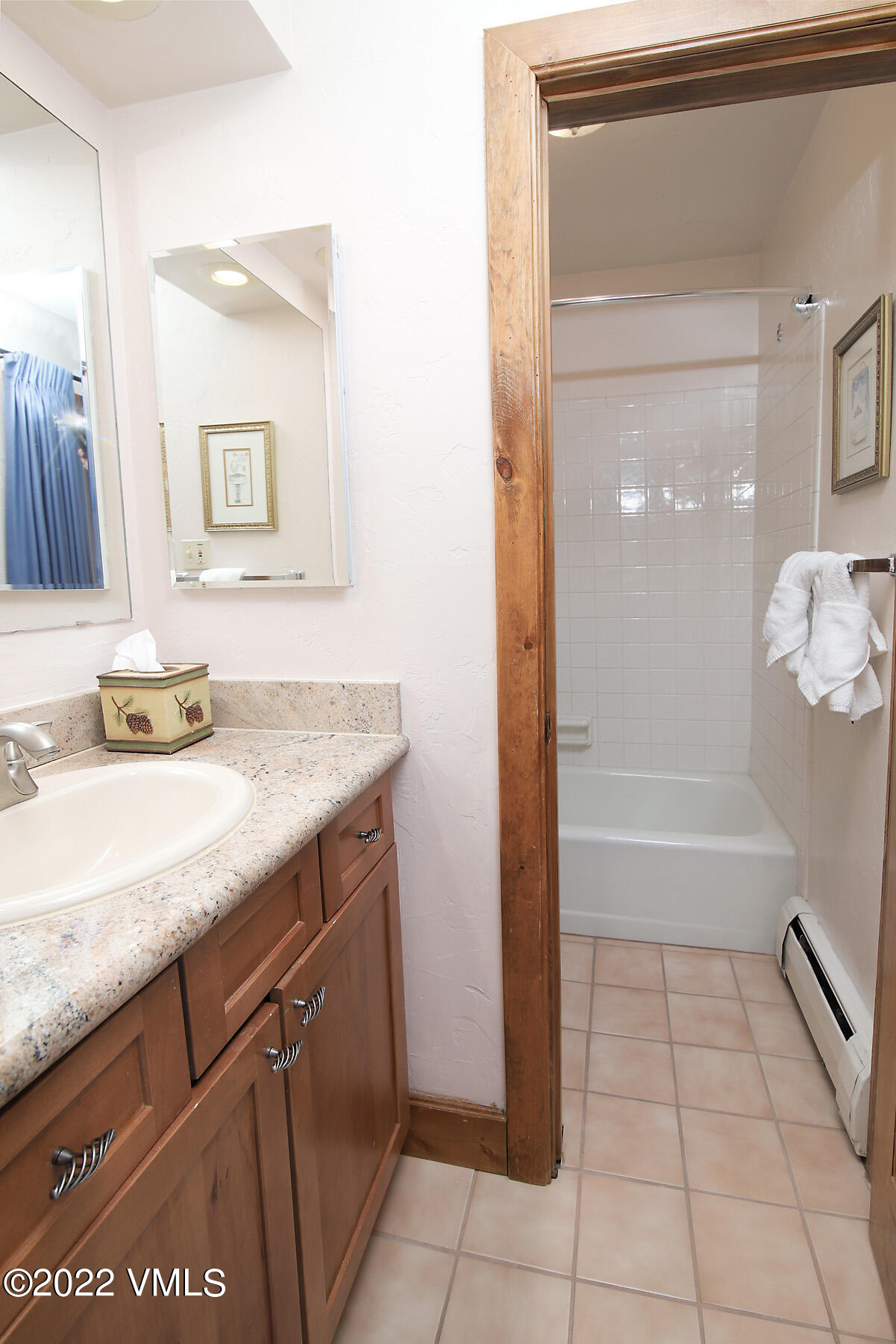 548 South Frontage Road West, Unit 105 Vail, CO 81657 - Photo 14 of 19 a bathroom with a granite countertop sink a mirror and a bathtub