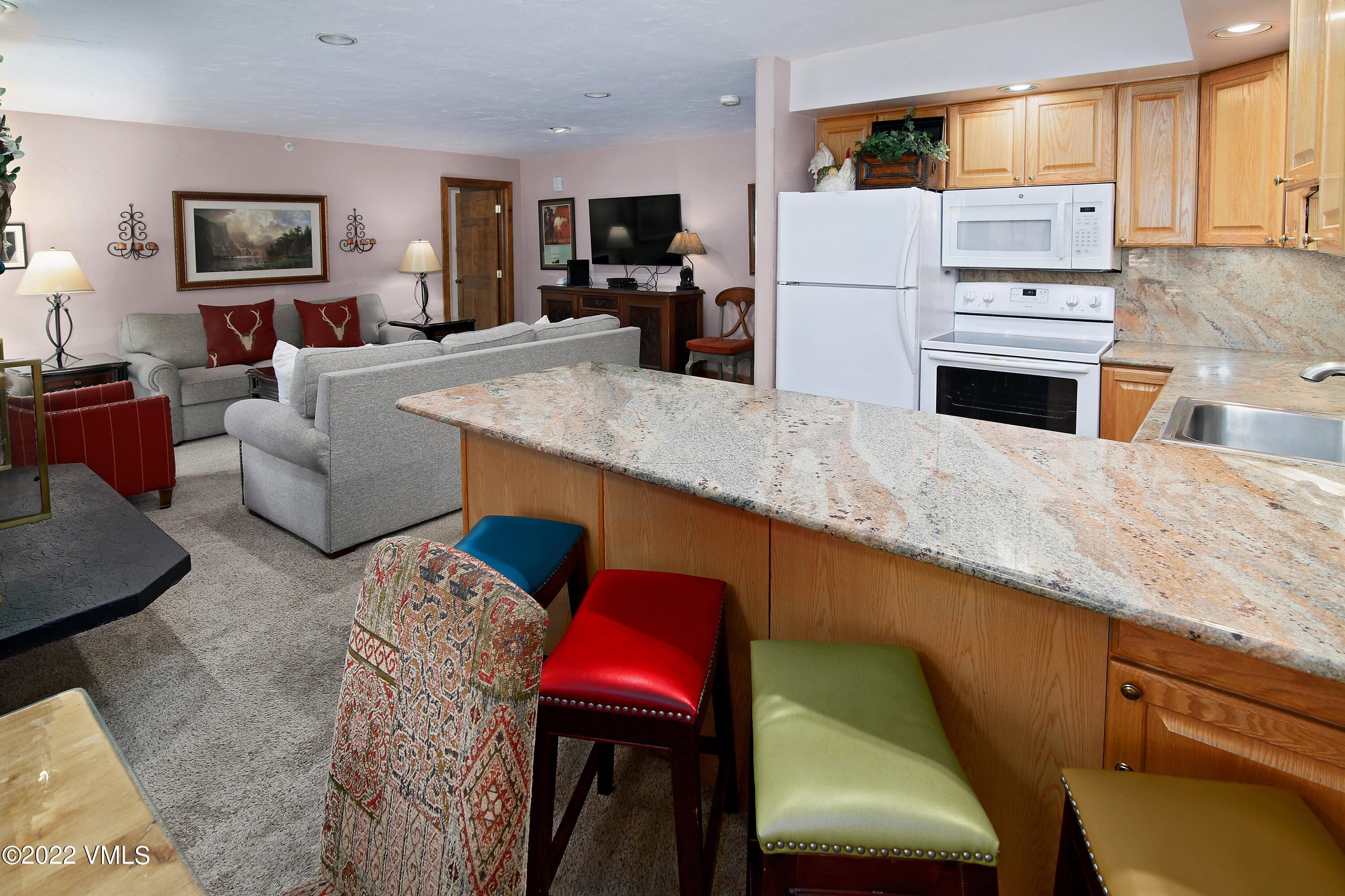 548 South Frontage Road West, Unit 105 Vail, CO 81657 - Photo 3 of 19 a kitchen with stainless steel appliances granite countertop a refrigerator and a stove top oven