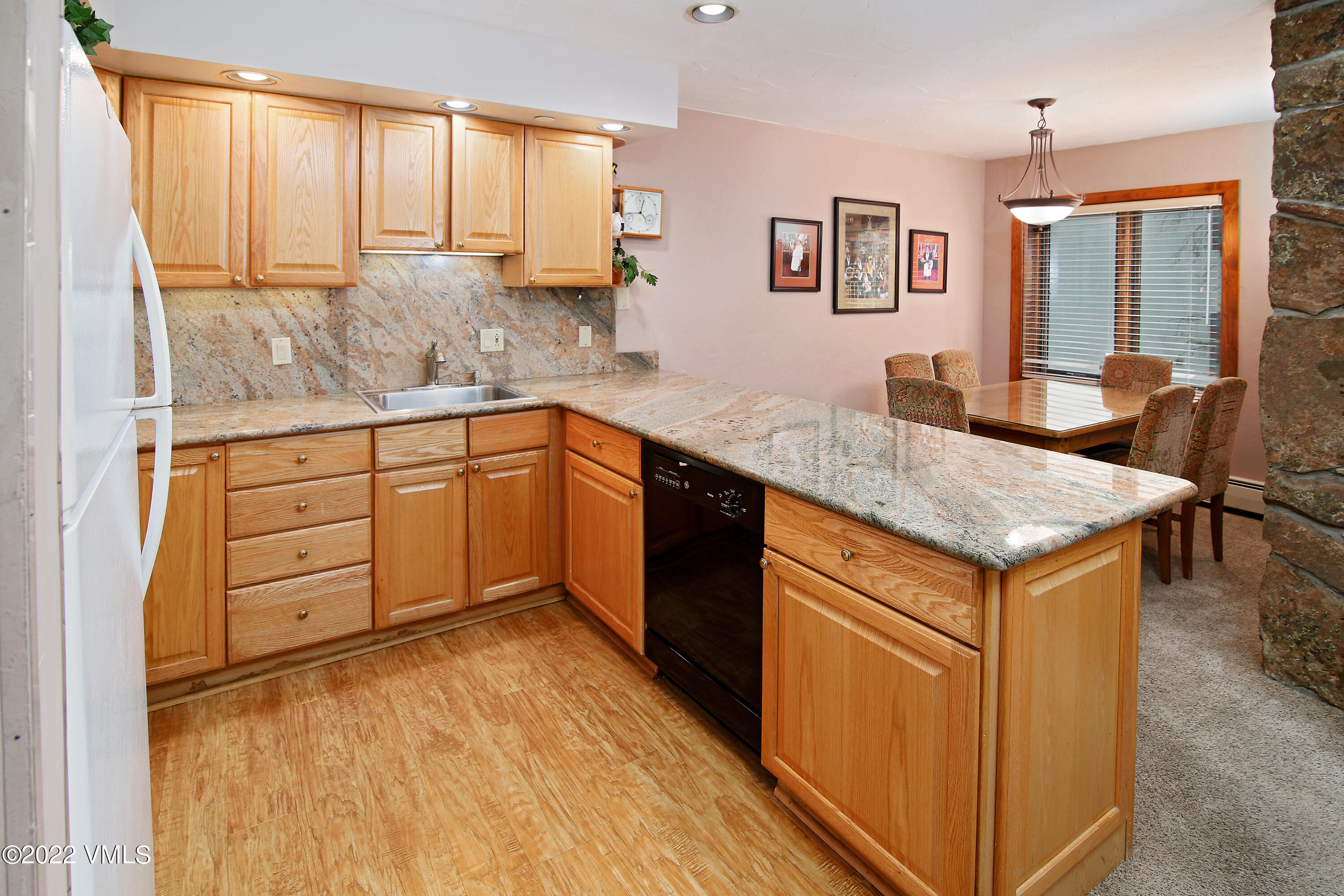 548 South Frontage Road West, Unit 105 Vail, CO 81657 - Photo 5 of 19 a kitchen with granite countertop a sink and cabinets