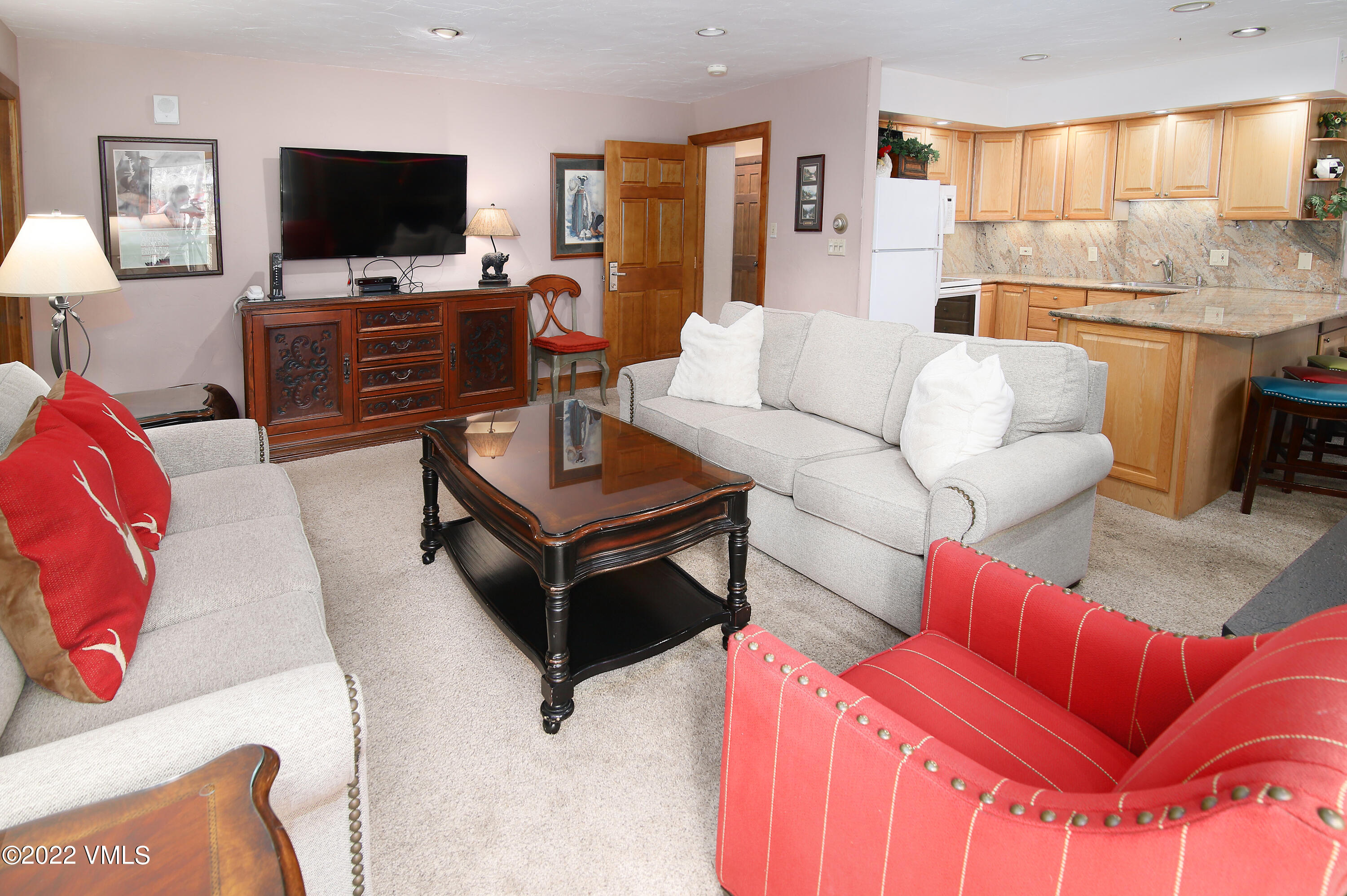 548 South Frontage Road West, Unit 105 Vail, CO 81657 - Photo 7 of 19 a living room with furniture and a flat screen tv