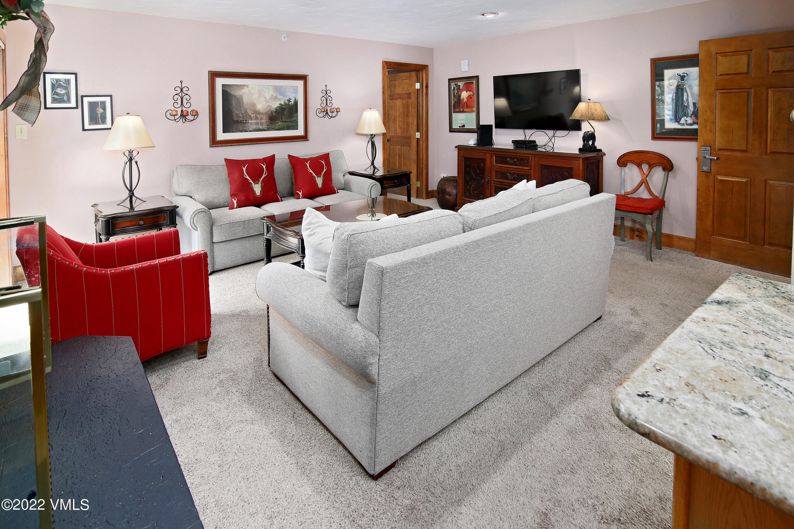 548 South Frontage Road West, Unit 105 Vail, CO 81657 - Photo 8 of 19 a living room with furniture and a flat screen tv