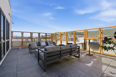 a living room with furniture and a floor to ceiling window